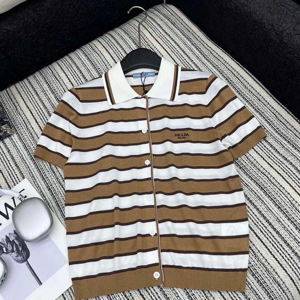Close-up of button and stripe detail on Prada cotton cardigan