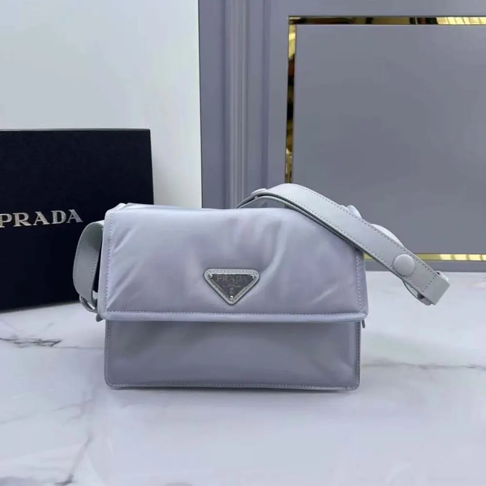 Close-up of silver hardware on Prada Women Small Padded Re-Nylon Shoulder Bag-Blue