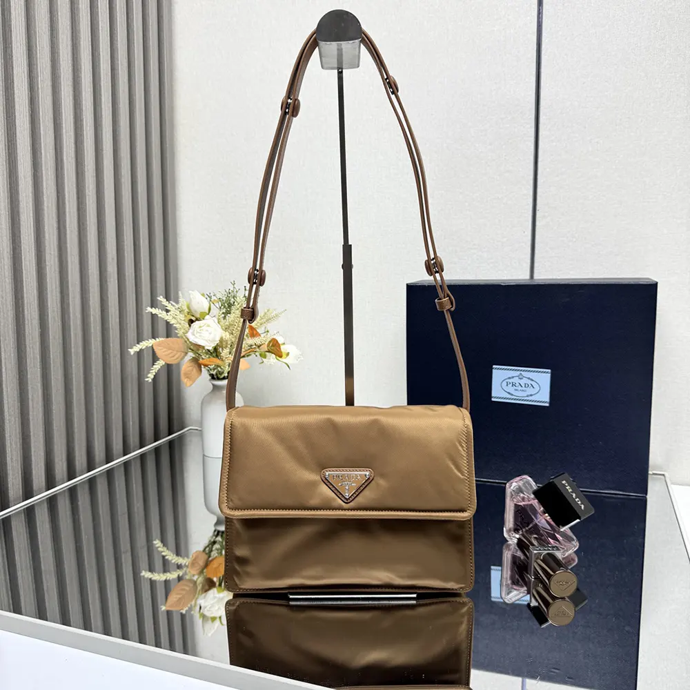 Close-up of silver-tone hardware on Prada Women Small Padded Re-Nylon Shoulder Bag-Brown