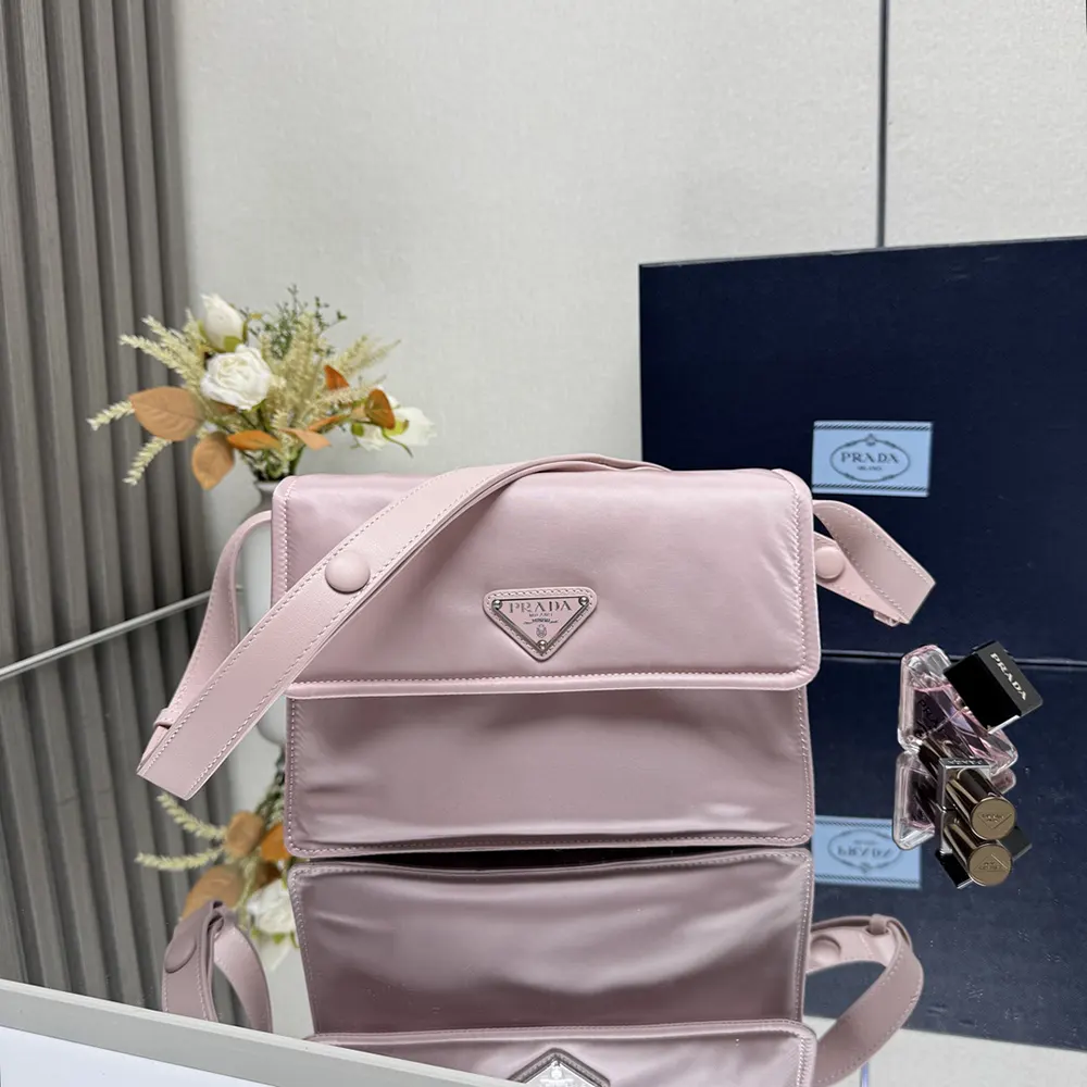 Side angle showing adjustable shoulder strap of Prada Small Padded Bag