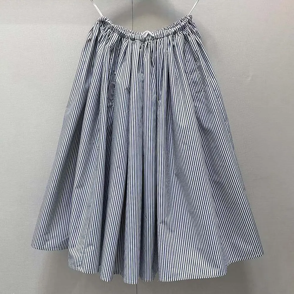 Side angle showing A-line silhouette of Prada Women Striped Poplin Skirt