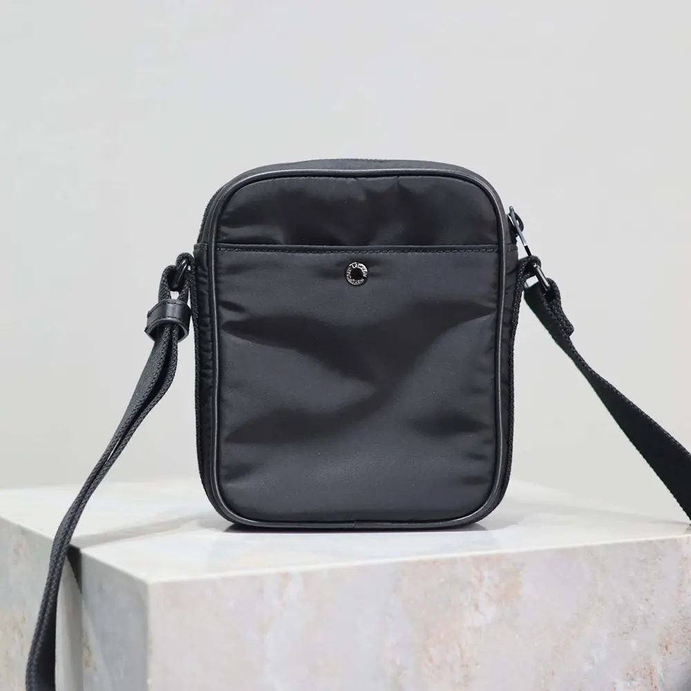Side angle showcasing zip closure and leather pull on Saint Laurent mini bag