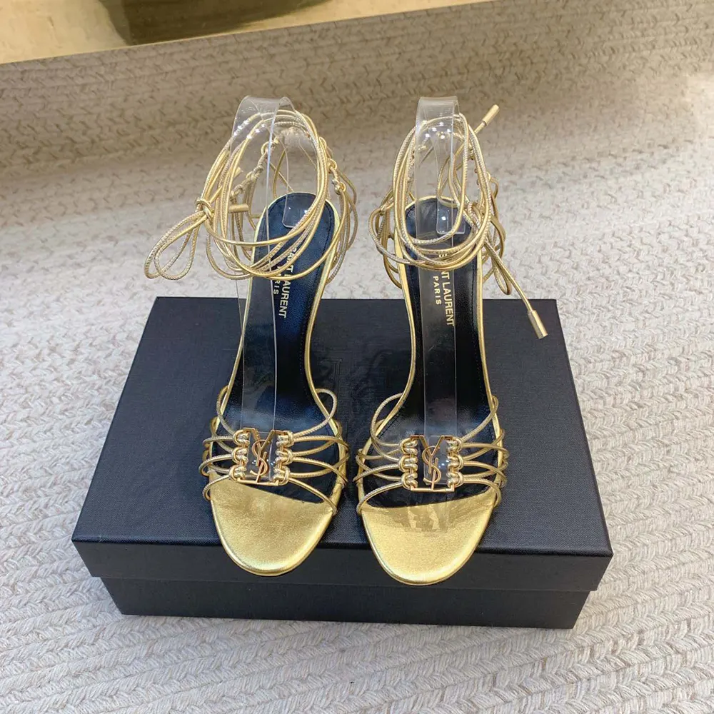 Close-up of gold YSL monogram hardware on Babylone Sandals