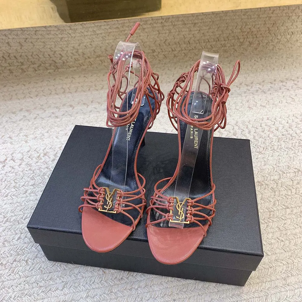 Close-up of gold YSL logo hardware on Babylone Sandals smooth leather