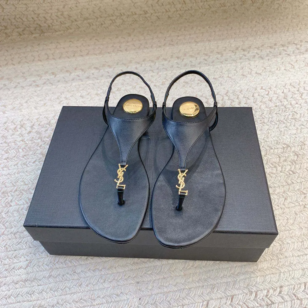 Close-up of gold YSL logo hardware on Saint Laurent YSL Women Cassandra Sandals