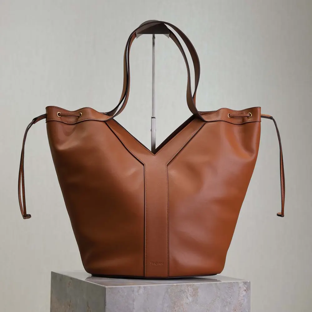 Close-up of gold YSL hardware on brown leather Saint Laurent YSL Large Hobo