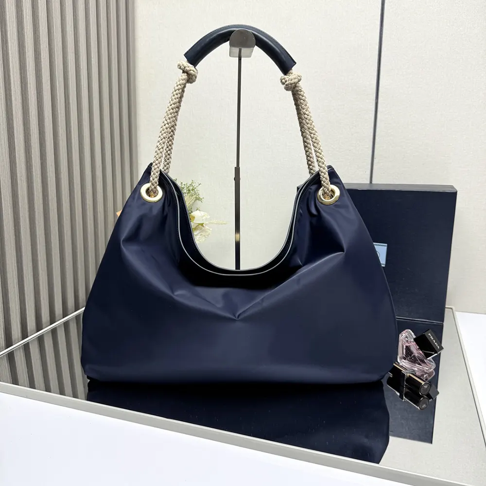 Side angle showing spacious interior of Prada Women Mariner Large Re-Nylon Shoulder Bag-Navy