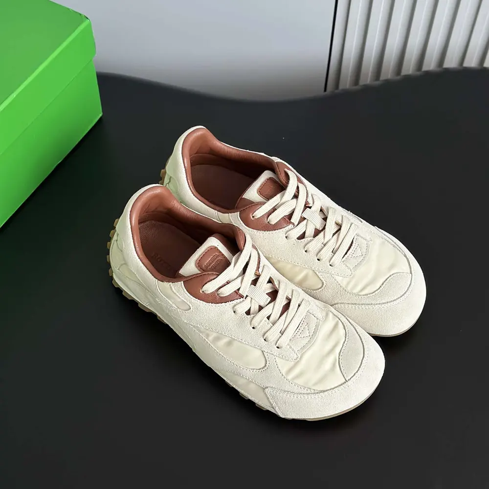 Close-up of beige leather and embossed logo on Bottega Veneta Orbit Flash Sneaker