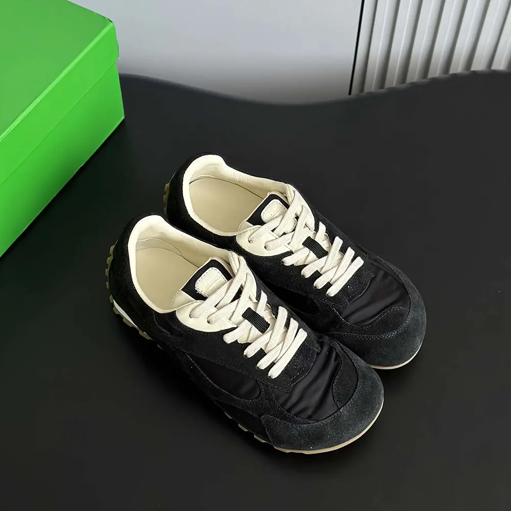 Top angle of Bottega Veneta Unisex Orbit Flash Sneaker-Black highlighting lace closure
