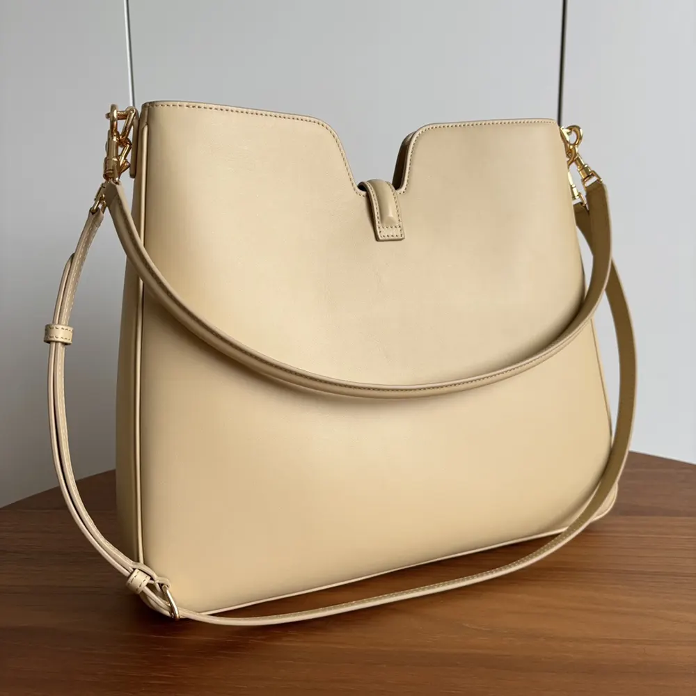 Side angle showing strap and silhouette of Celine Women Medium Camille 16 Soft Bag