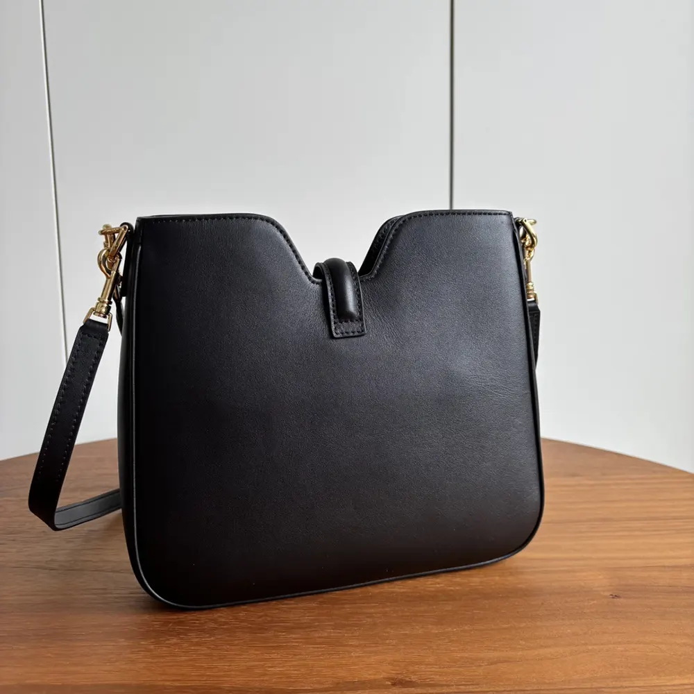 Side angle showing soft silhouette of Celine Women Small Camille 16 Soft Bag