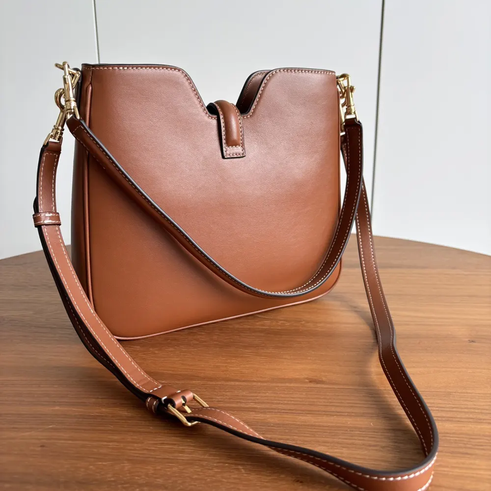 Side angle showing compact silhouette of Celine Women Small Camille 16 Soft Bag