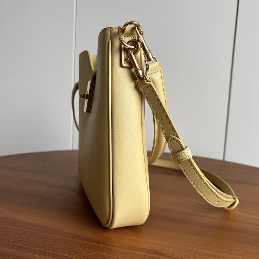 Side angle showing soft silhouette of Celine Women Small Camille 16 Yellow bag