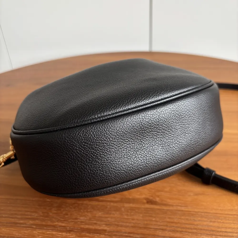 Side angle showing silhouette of Celine Women Teen Celine Llulu black bag