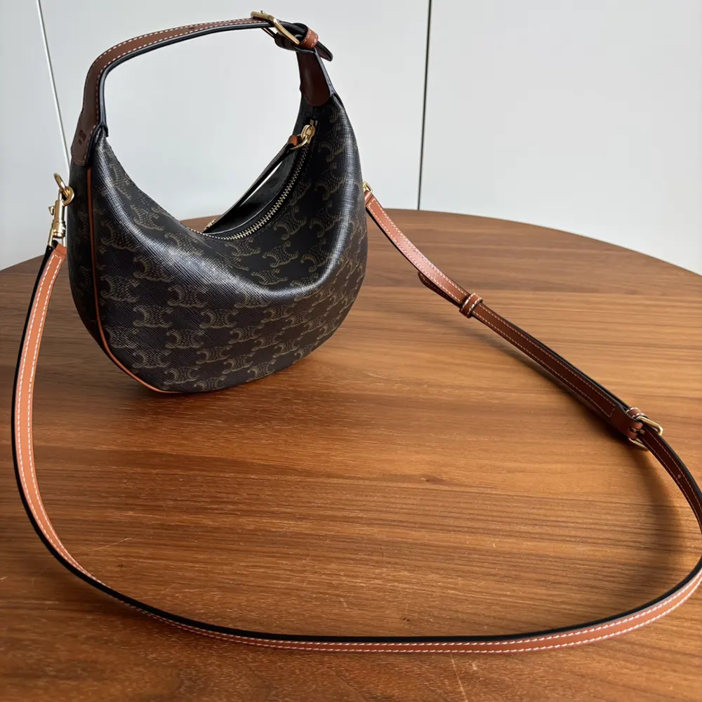 Side angle showing brown calfskin strap and canvas on Celine Women Teen Celine Lulu