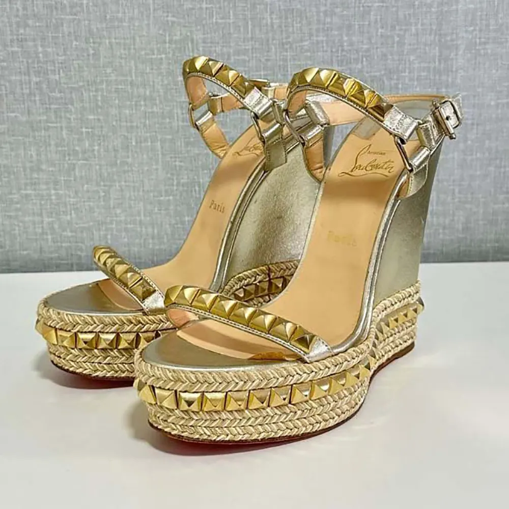 Close-up of gold calf leather and signature studs on Christian Louboutin espadrille