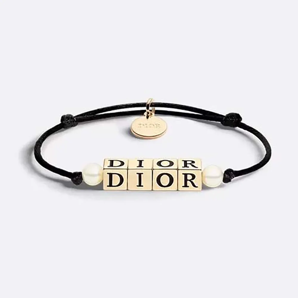 Close-up of Dior Women D-Dice Bracelet black cotton and lacquer detail