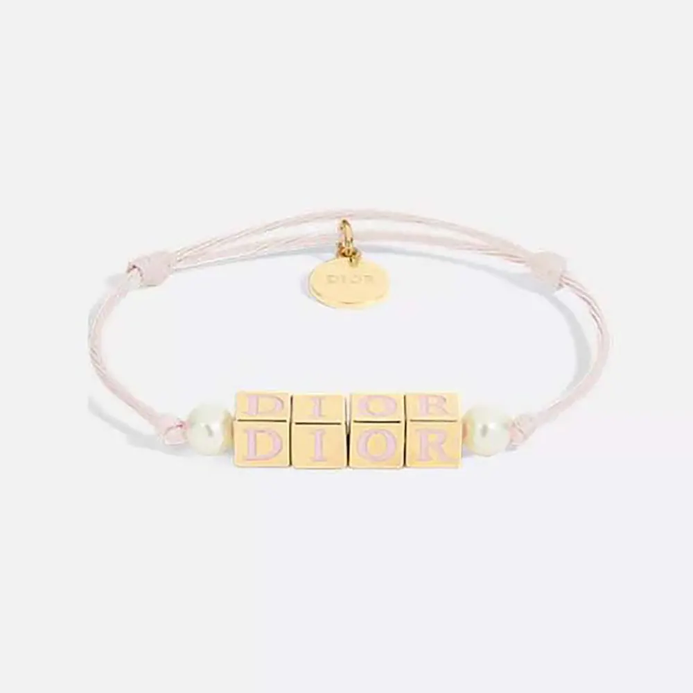 Close-up of Dior Women D-Dice Bracelet showing gold-finish metal and pearls