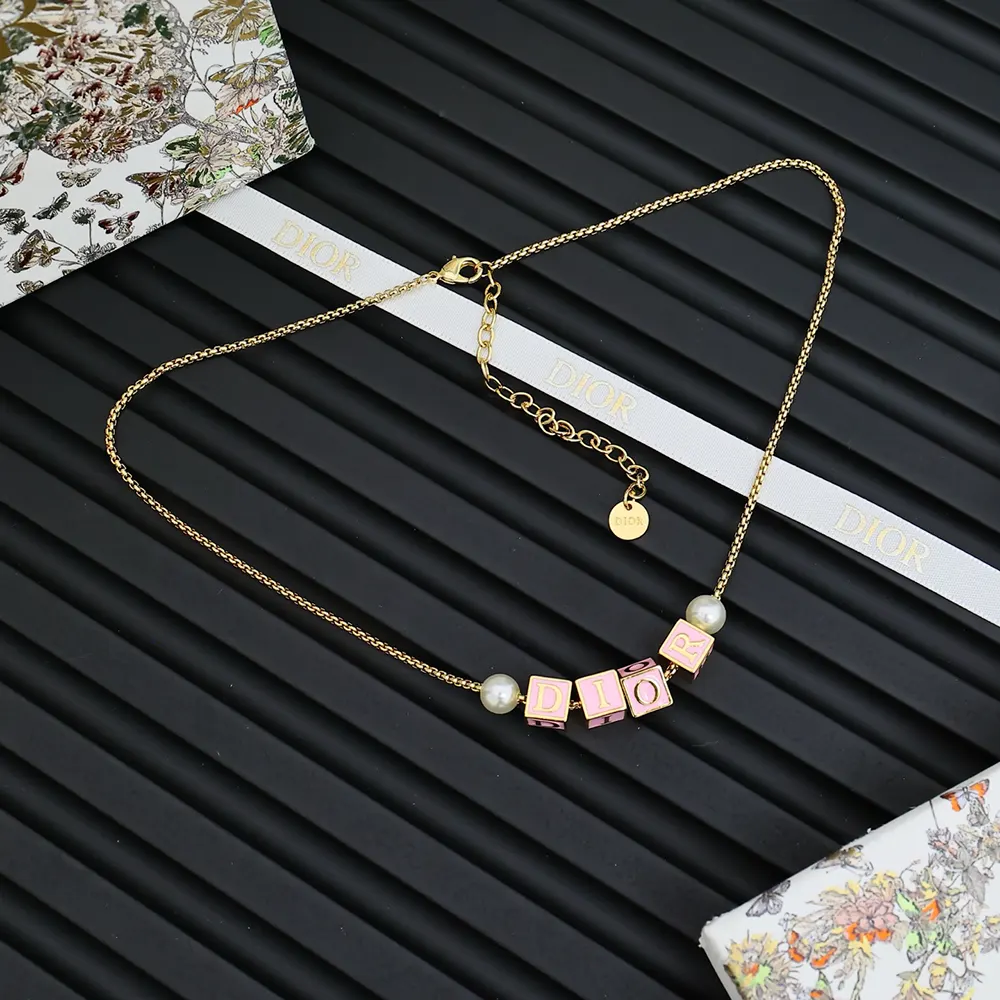 Close-up of Dior Women D-Dice Necklace gold finish and white resin pearls