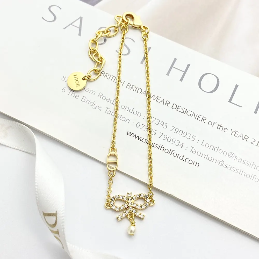 Close-up of gold-finish metal and silver-tone crystals on Dior necklace