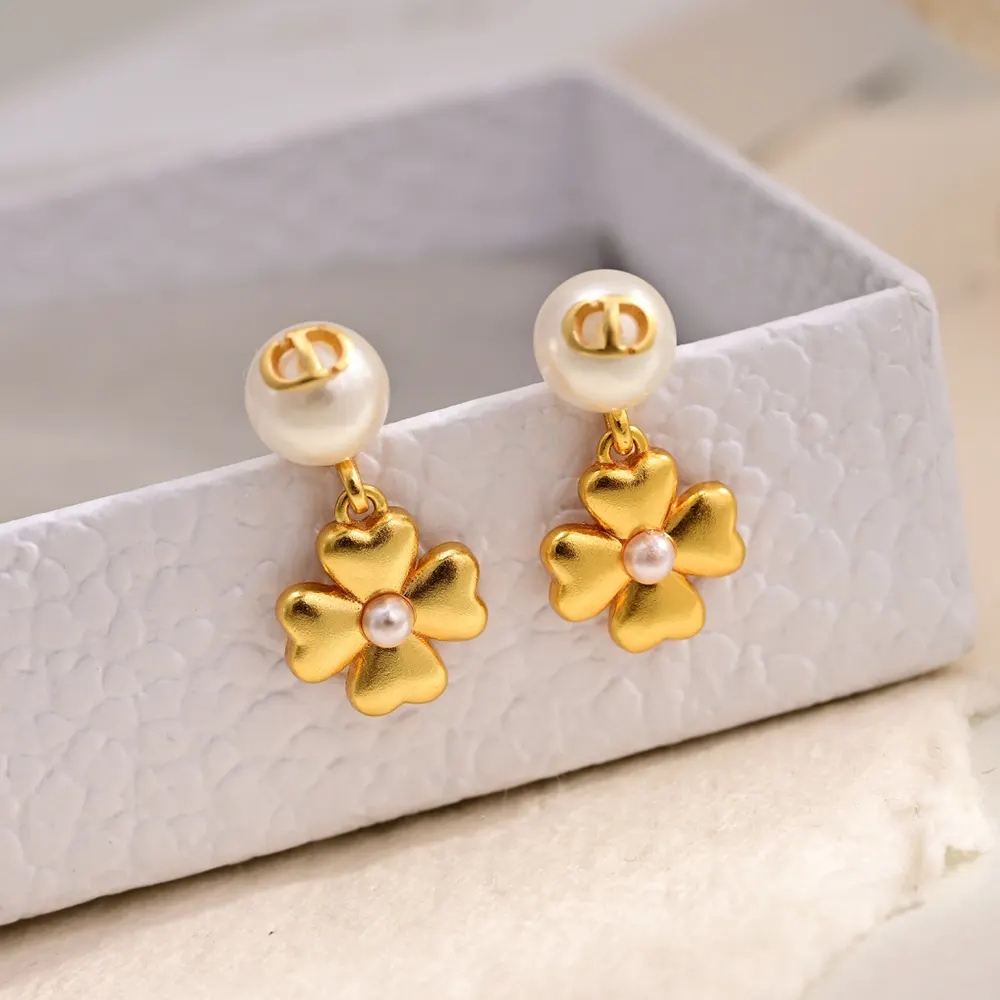 Side profile showing drop silhouette of Dior Women Lucky Dior Earrings