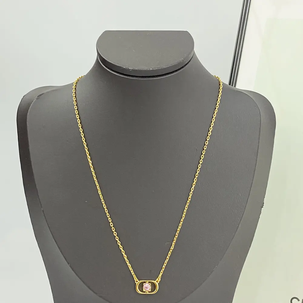 Detail of pink crystal and CD logo on Dior Women Petit CD Jolie Necklace