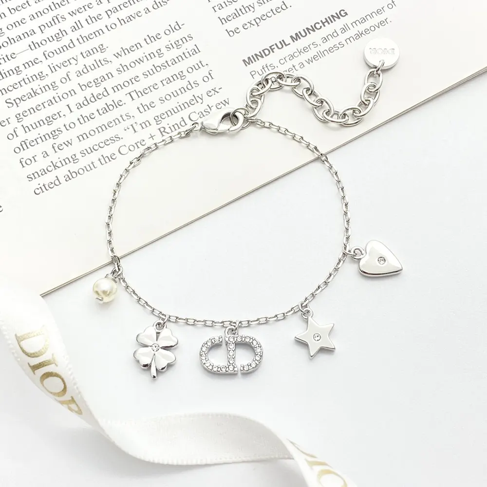 Side angle showing silver-finish metal and white resin pearl bracelet