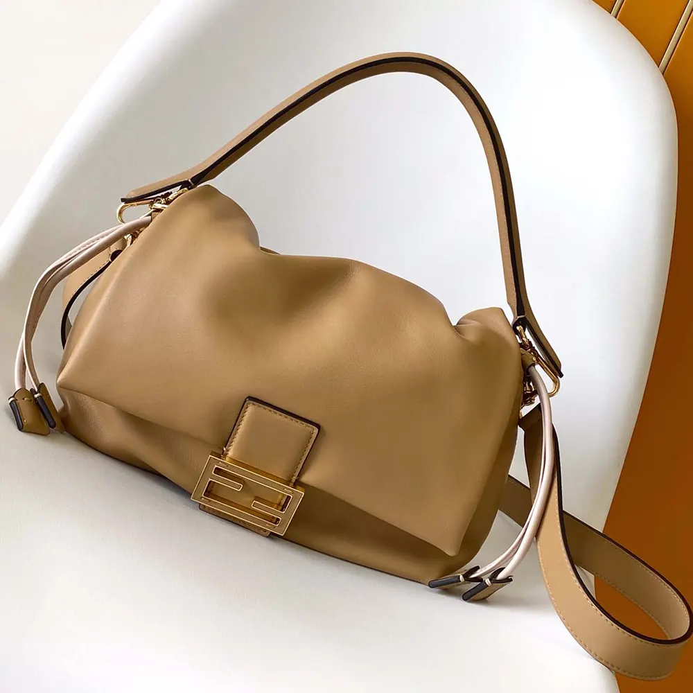 Close-up on gold-tone Fendi hardware and flap of the medium brown bag