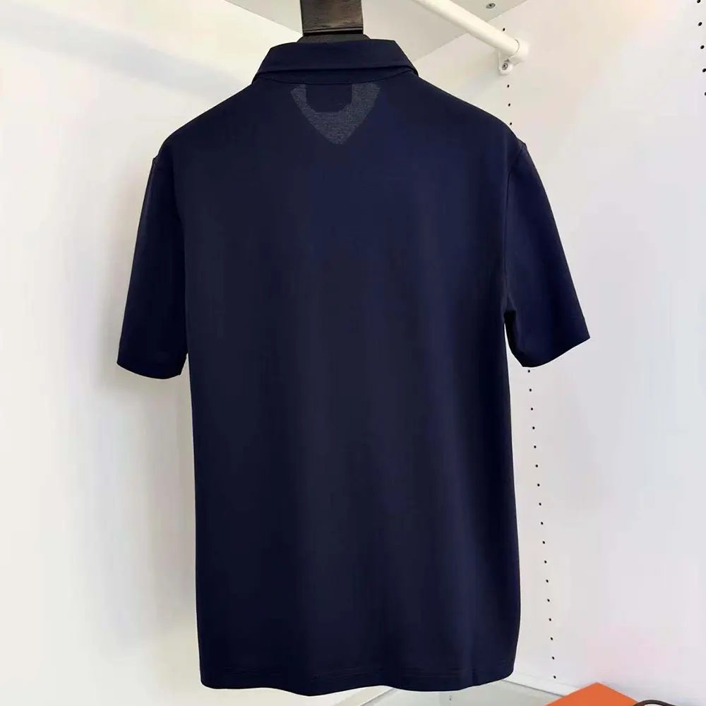 Close-up of Hermes Men Polo Shirt with Pocket-Navy/Brown cotton texture and brown trim