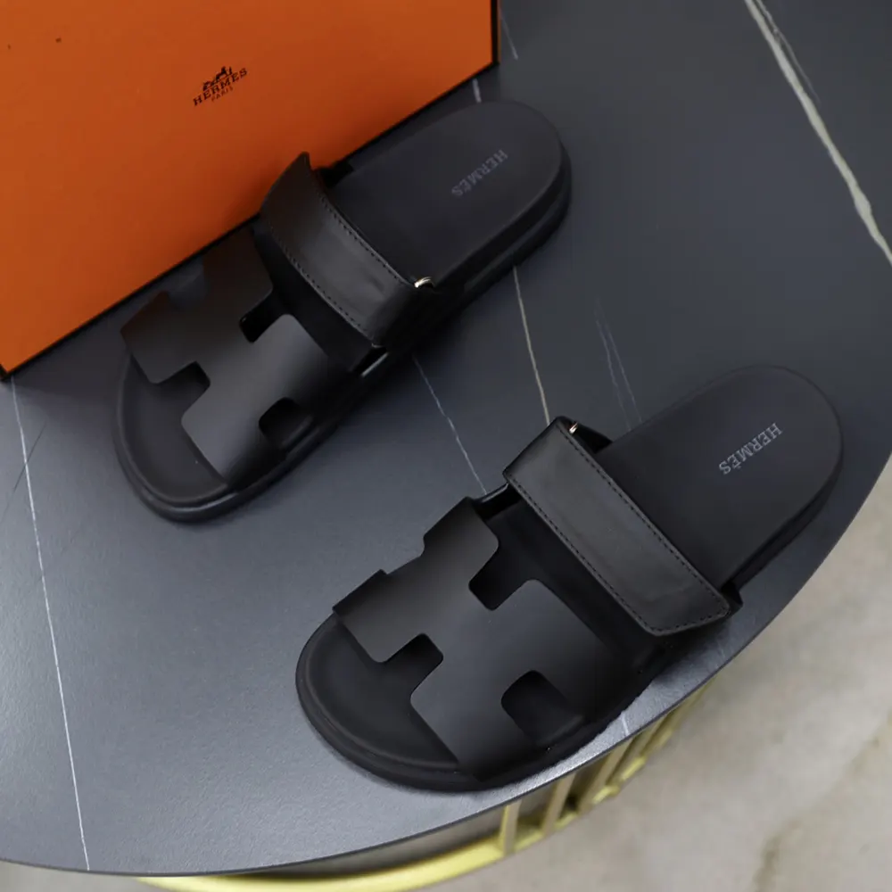 Top angle of Hermes Unisex Chypre Sandal-Black highlighting open-toe design