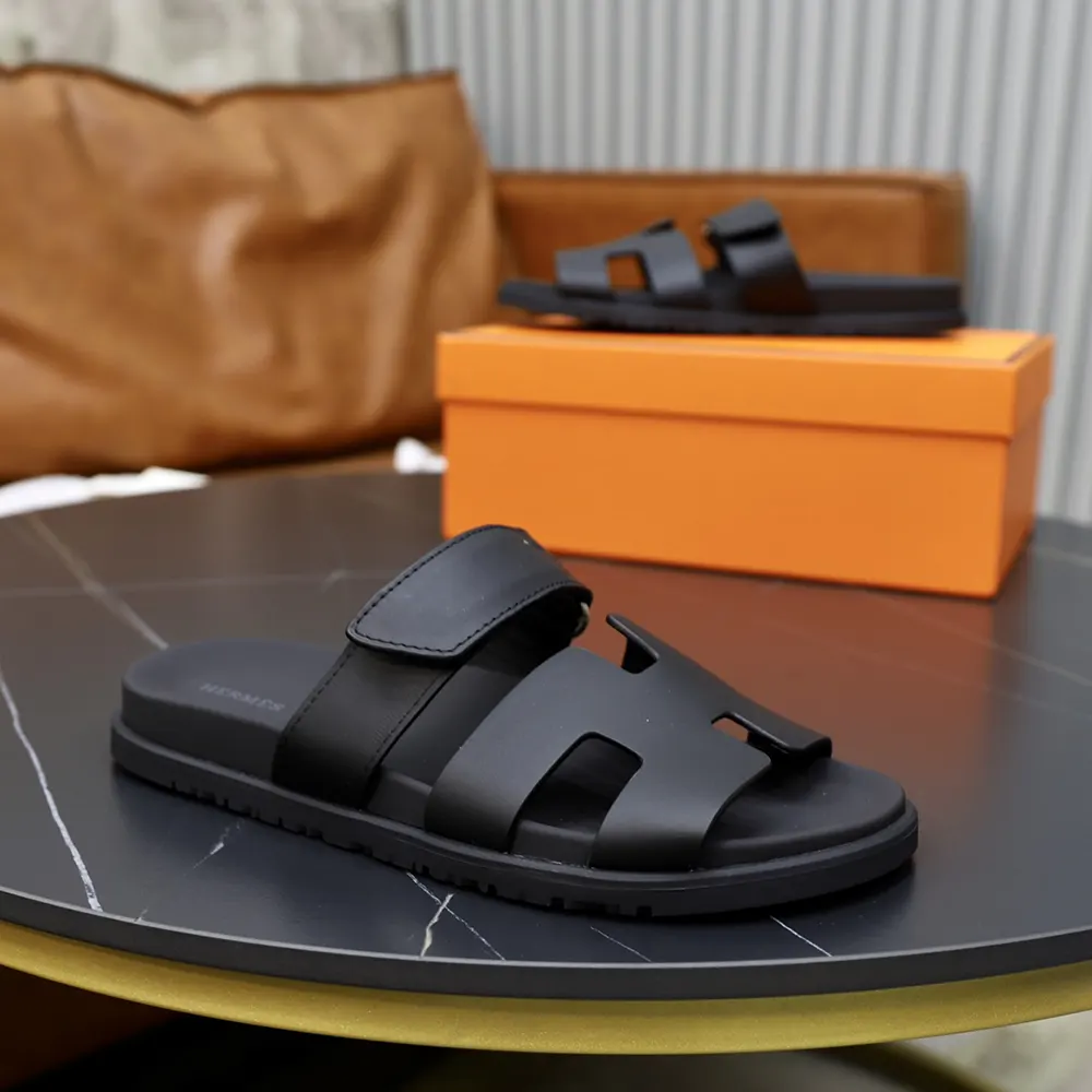 Close-up of black leather and signature H cut-out on Hermes sandal