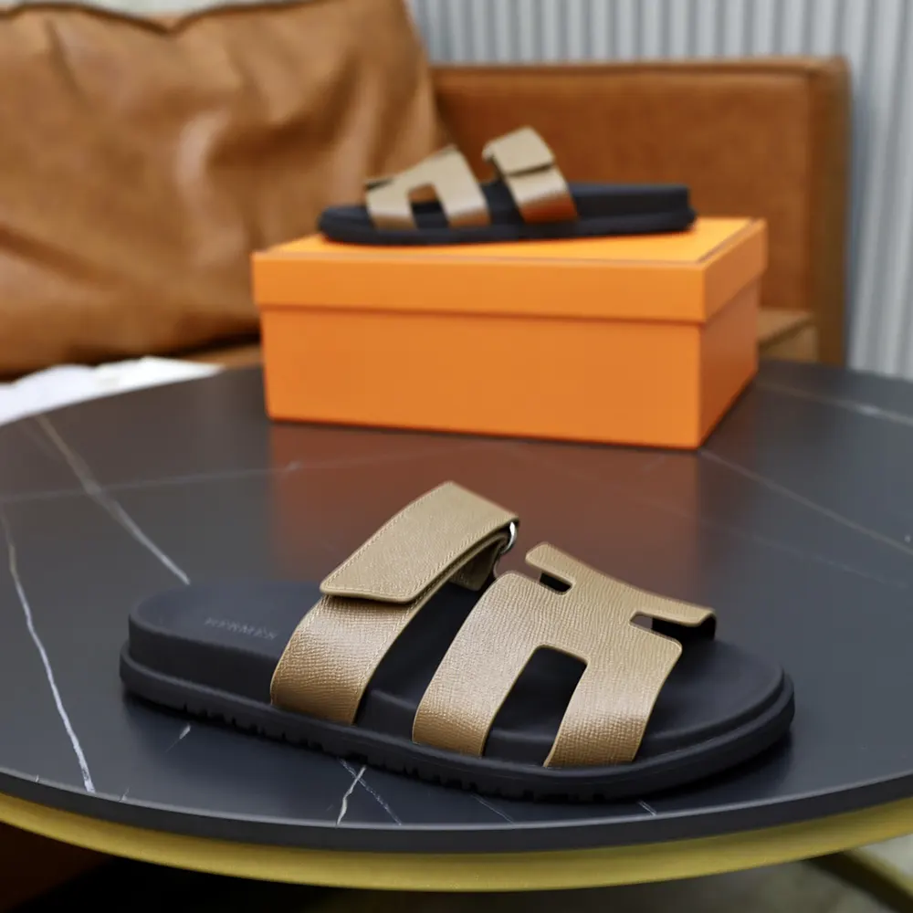 Close-up of smooth brown leather and cut-out design on Hermes sandal