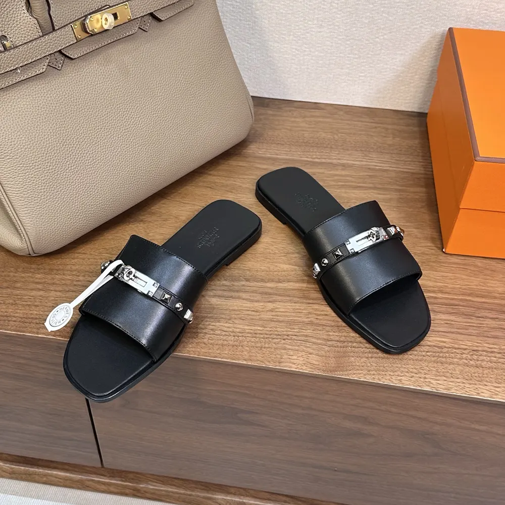 Close-up of black Hermes hardware on Giulia Sandal-Black strap