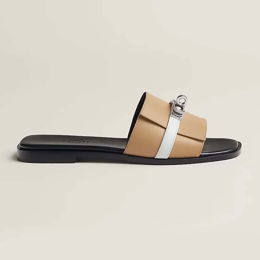 Side angle of Hermes Unisex Giulia sandal-Sandy/White showing leather texture