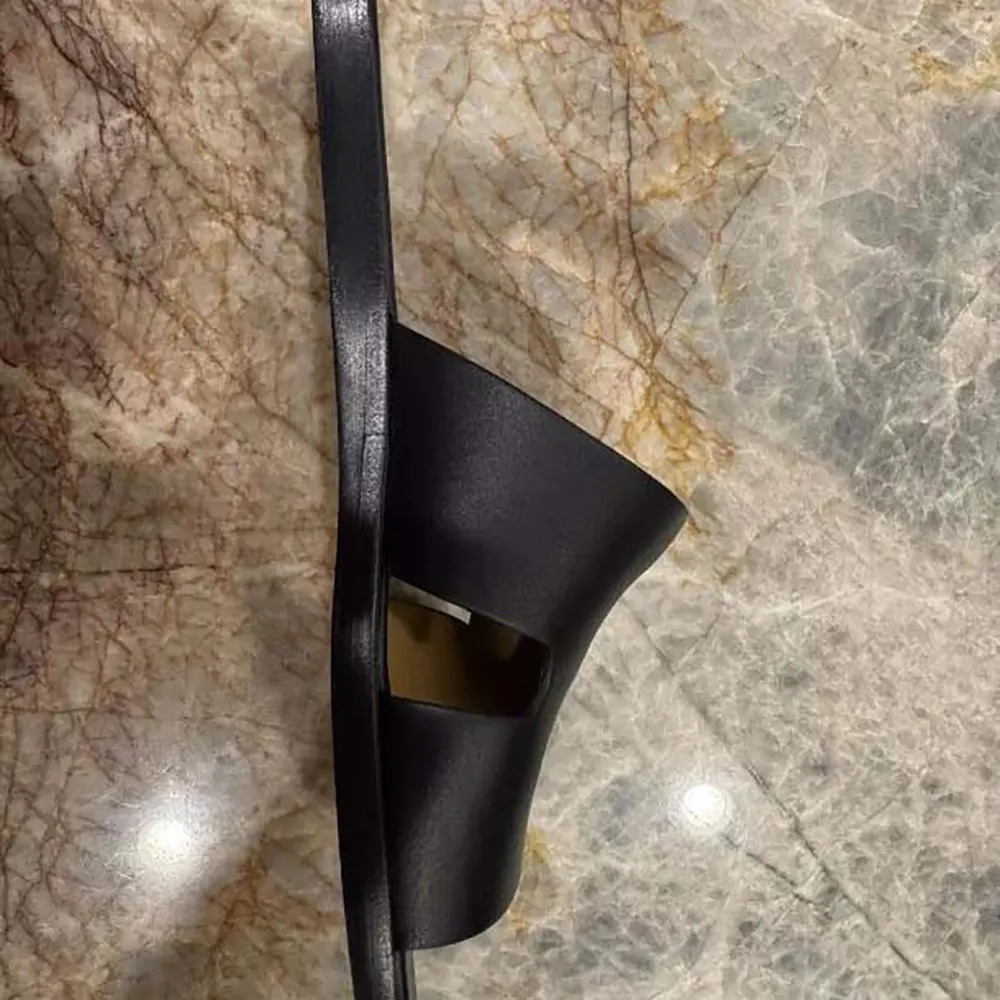 Close-up on sole and Hermes silver hardware of Izmir Sandal-Black