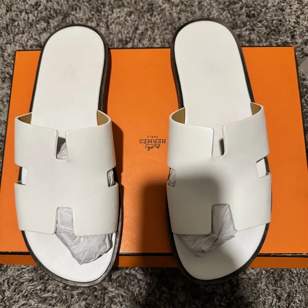 Overhead shot of Hermes Unisex Izmir Sandal-White highlighting signature cut-out