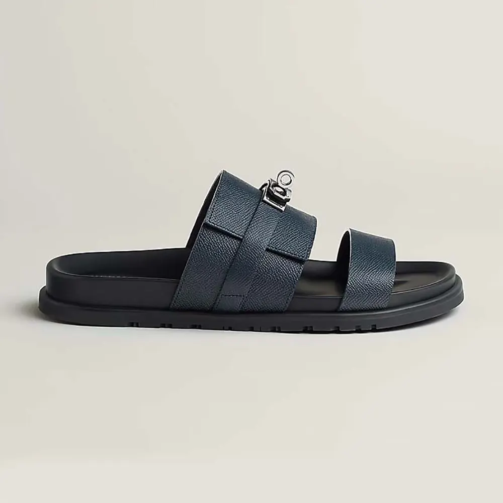 Side view of Hermes Unisex Jackson Sandal-Navy showing signature H cutout
