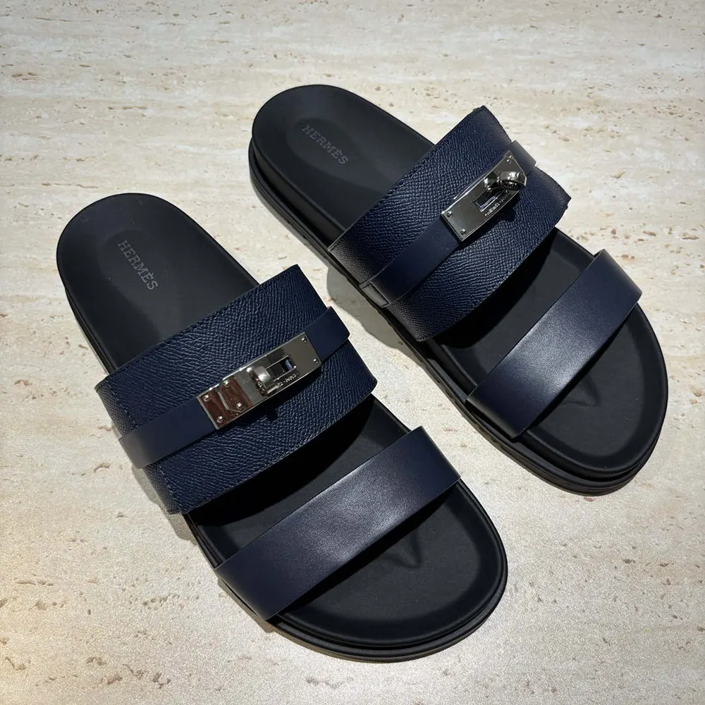 Close-up of rubber sole and stitching on Hermes Unisex Jackson Sandal-Navy