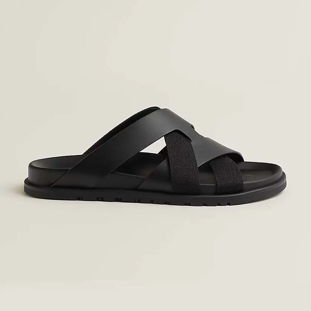 Side angle of Hermes Unisex Kazimir Sandal-Black showing leather texture