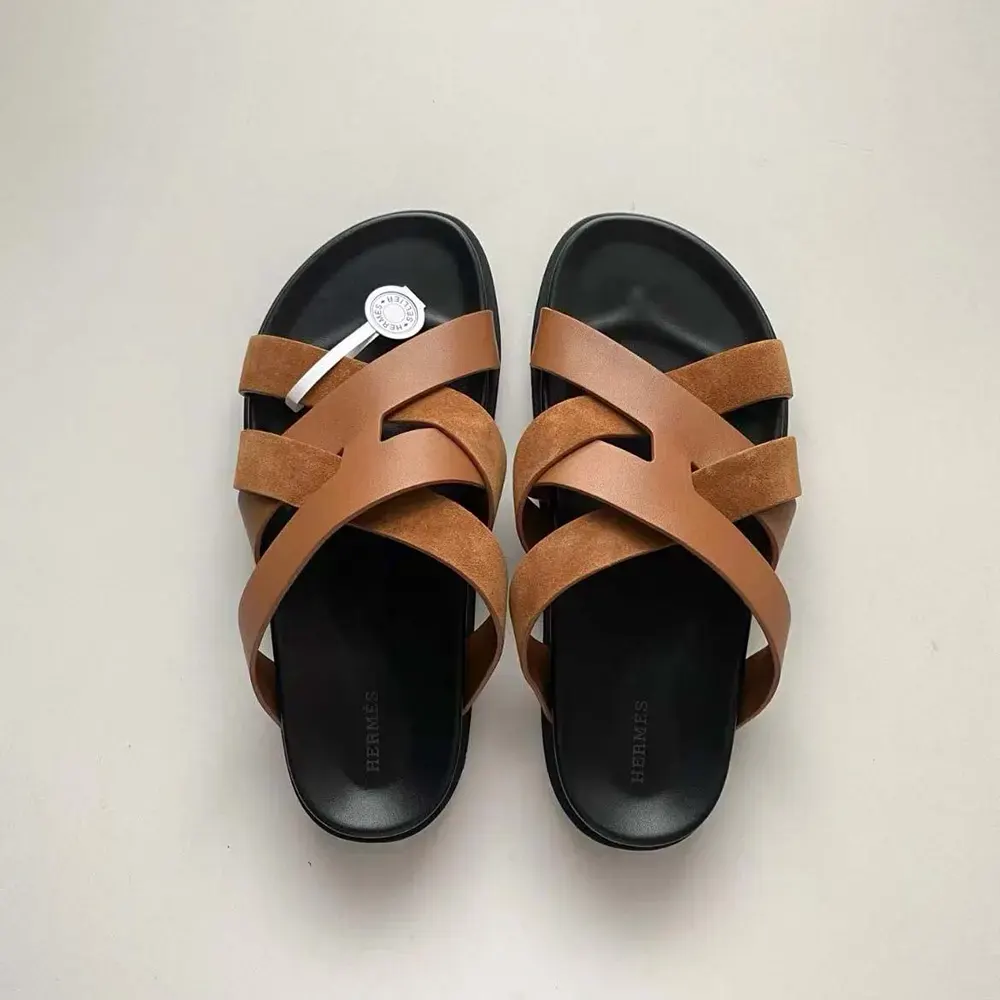 Close-up of brown calfskin leather and polished buckle on Hermes sandal