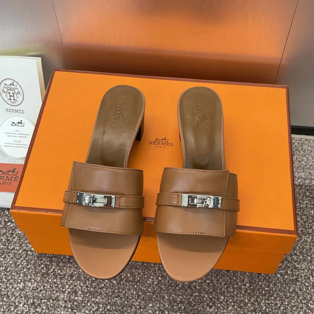 Close-up on Hermes signature ‘H’ hardware detail on sandal strap