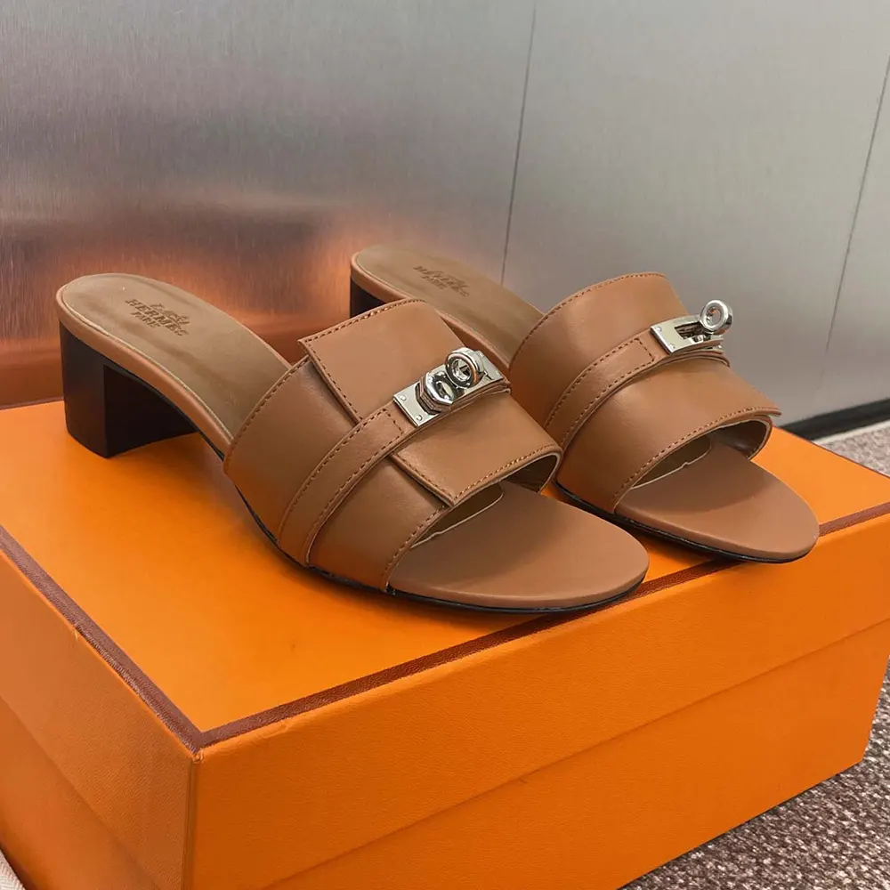Rear angle of Hermes Women Gigi 50 Sandal-Brown highlighting heel shape
