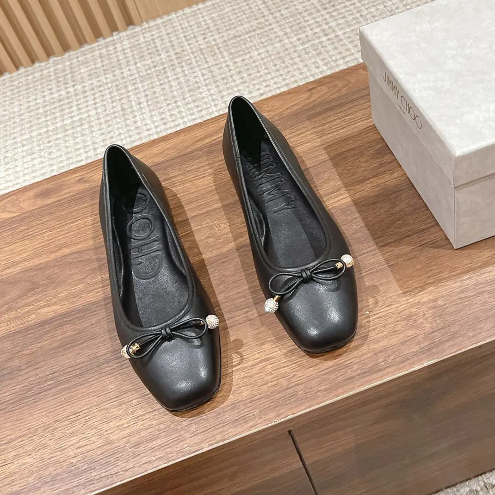 Close-up of pearl embellishment on Jimmy Choo Women Elme Flat Black Nappa Leather Flats