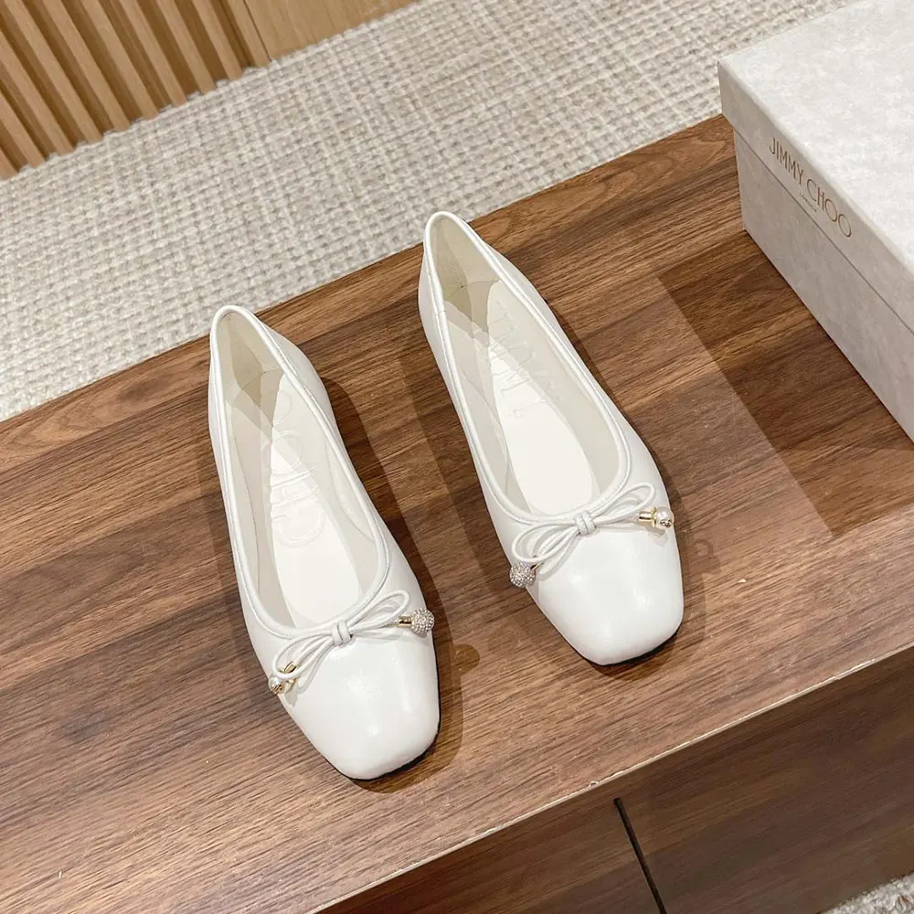 Close-up on pearl embellishment of Jimmy Choo Elme Flat Latte leather flats