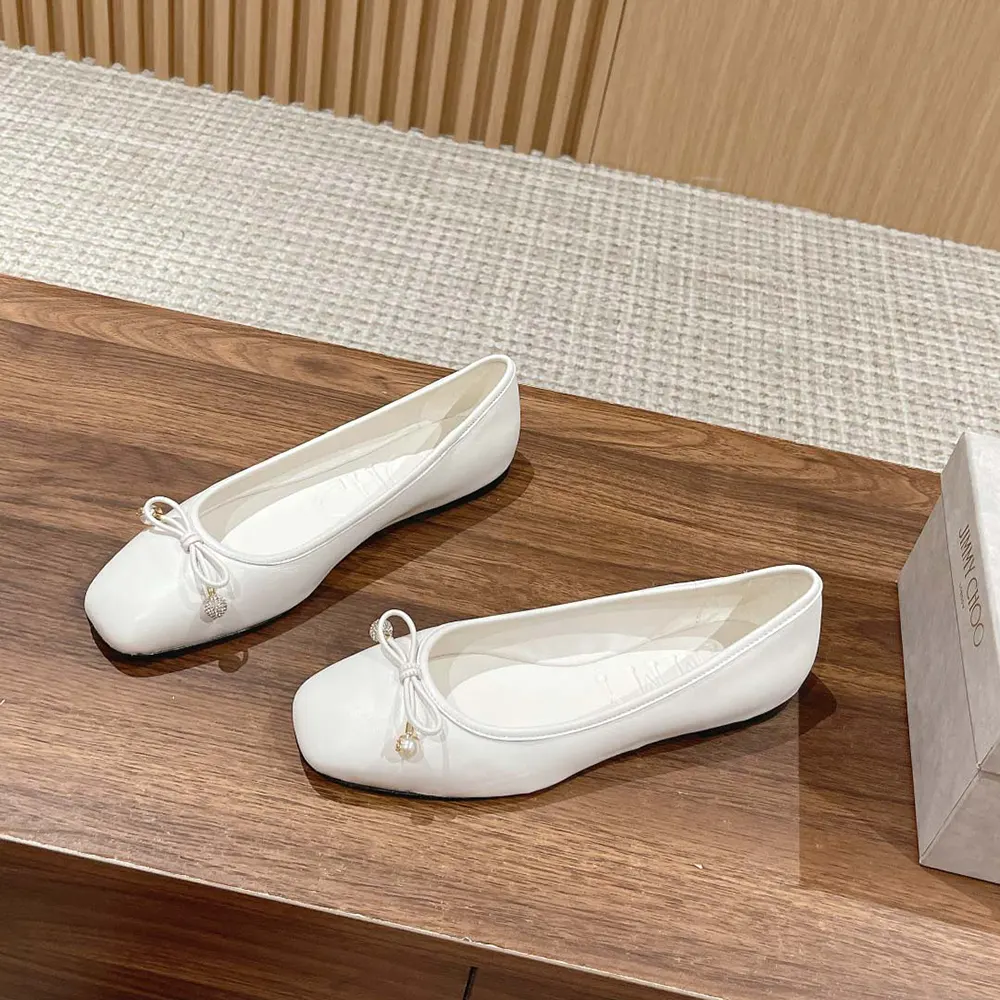 Side profile showing low stacked heel of Jimmy Choo Women Elme Flat Latte flats