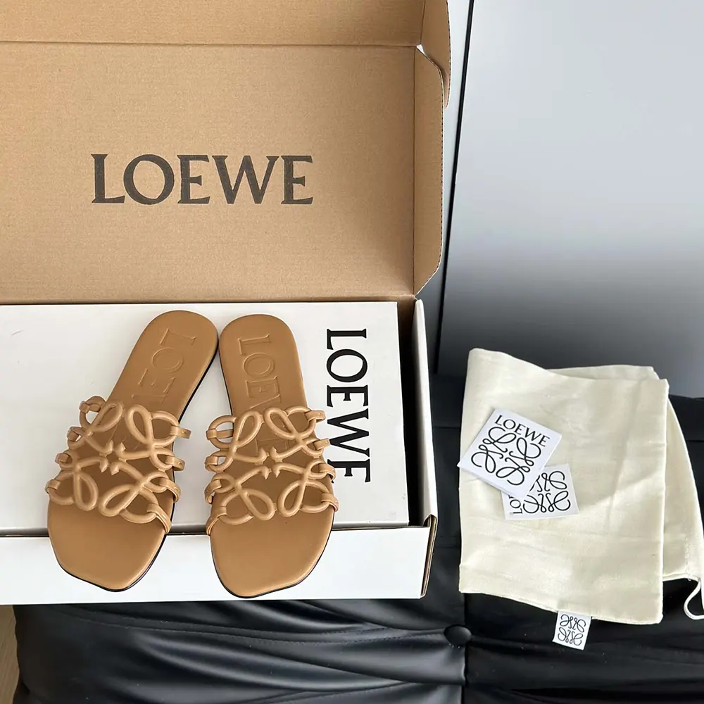 Close-up on Loewe Petal Anagram detail on brown slide sandal