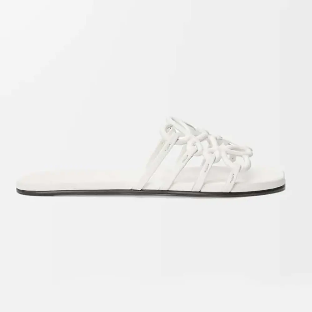 Side view of Loewe Women Petal Anagram Slide in Soft Calfskin-White