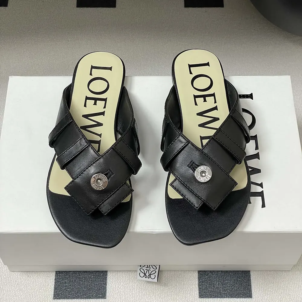 Close-up on lambskin texture and Loewe embossed logo detail on sandal