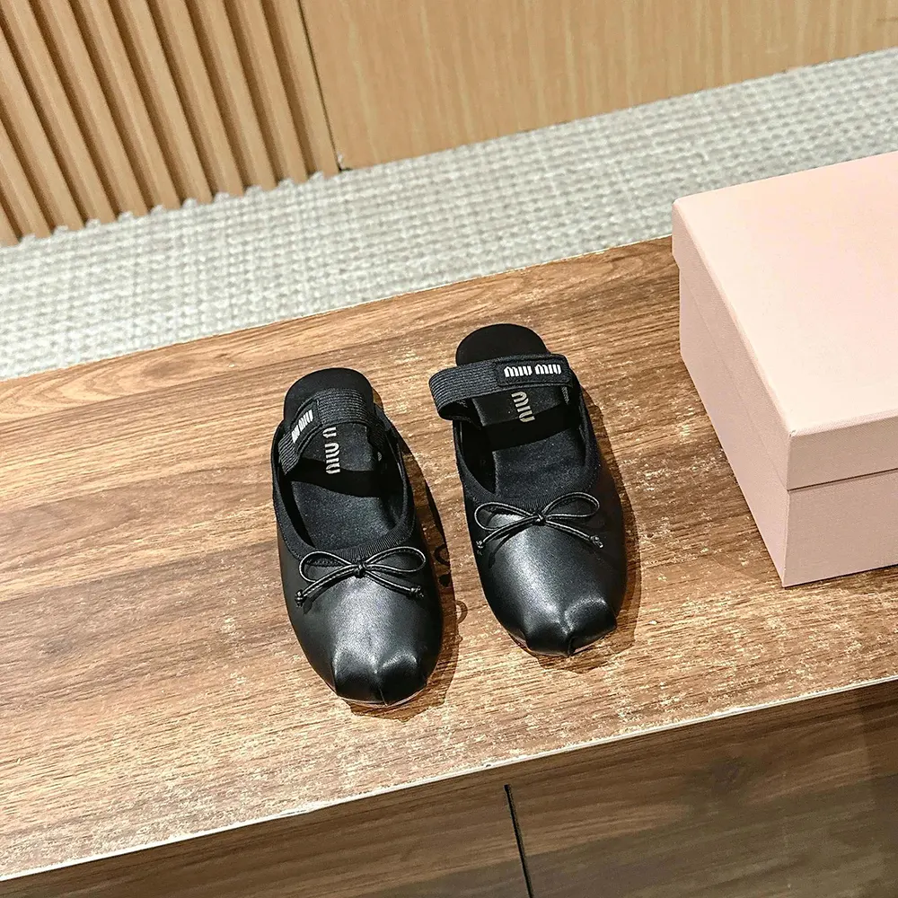 Close-up of smooth black leather and subtle logo on Miu Miu Ballerina Mules