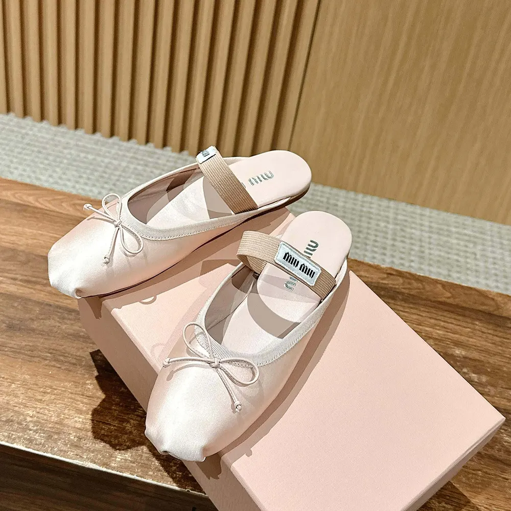 Top-down angle highlighting soft cushioned insole in Miu Miu satin mules
